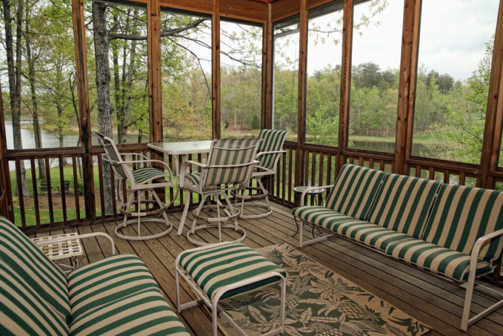 out door chairs and table inside screened-in porch 