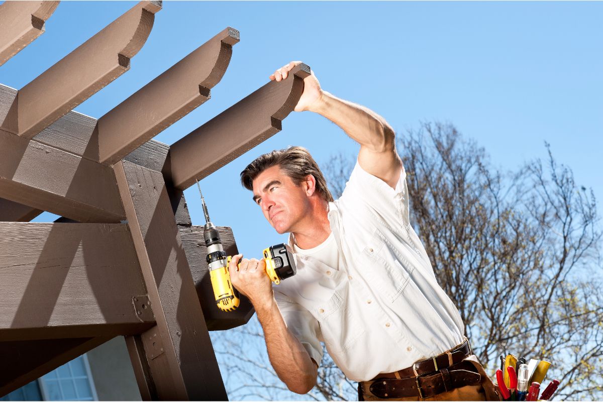 handyman working on pergola