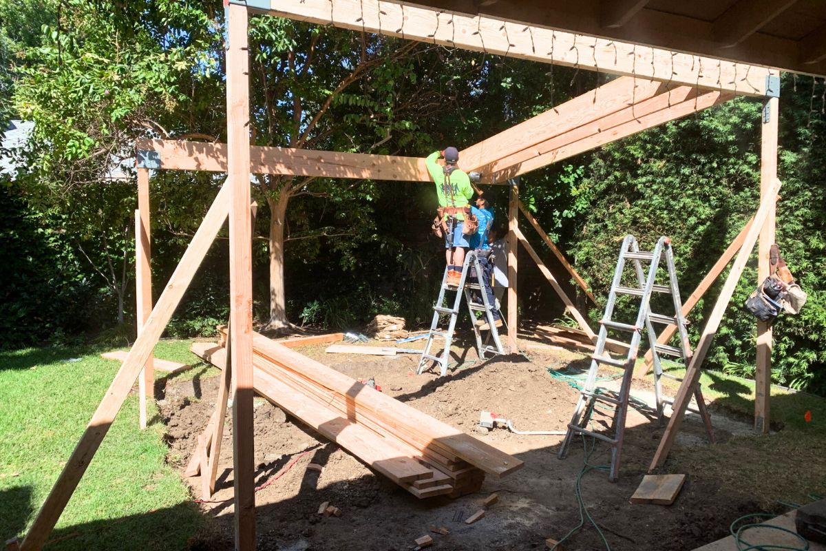 two contractors building pergolas