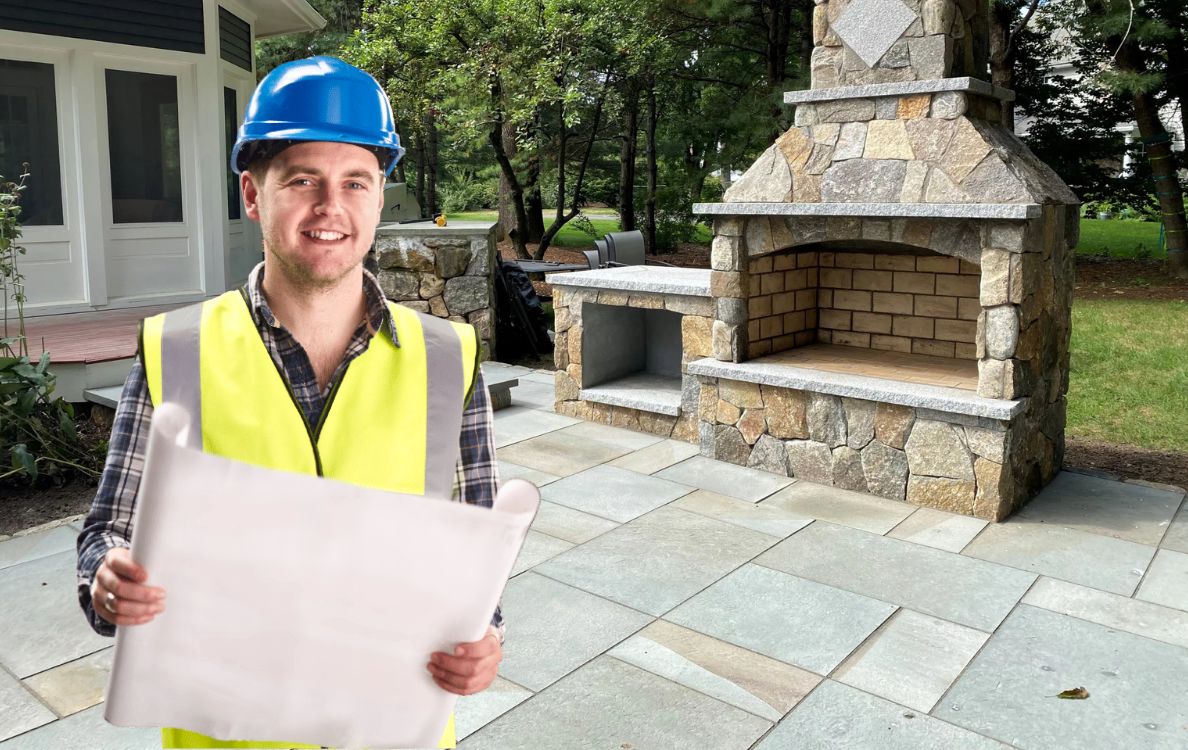 professional contractor holding blueprint for outdoor patio building